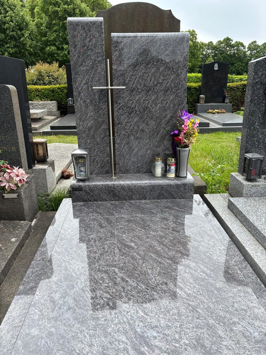 Grabanlage aus Orion-Granit mit zweiteiligem Grabstein, Sternenornament und Edelstahlkreuz, polierter Deckplatte sowie Laterne und Vase aus Aluminium am Wiener Zentralfriedhof